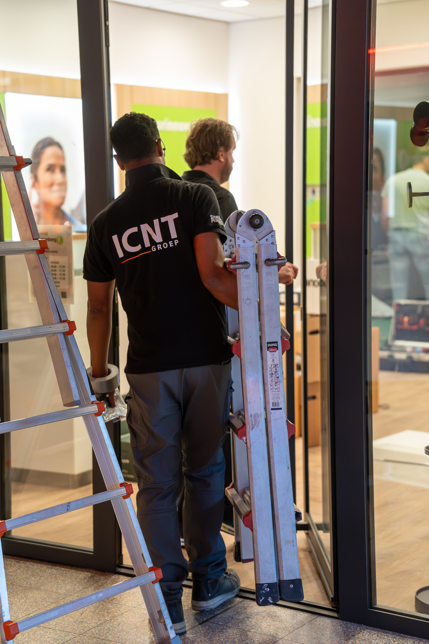 ICNT technicians installing equipment at a client entrance
