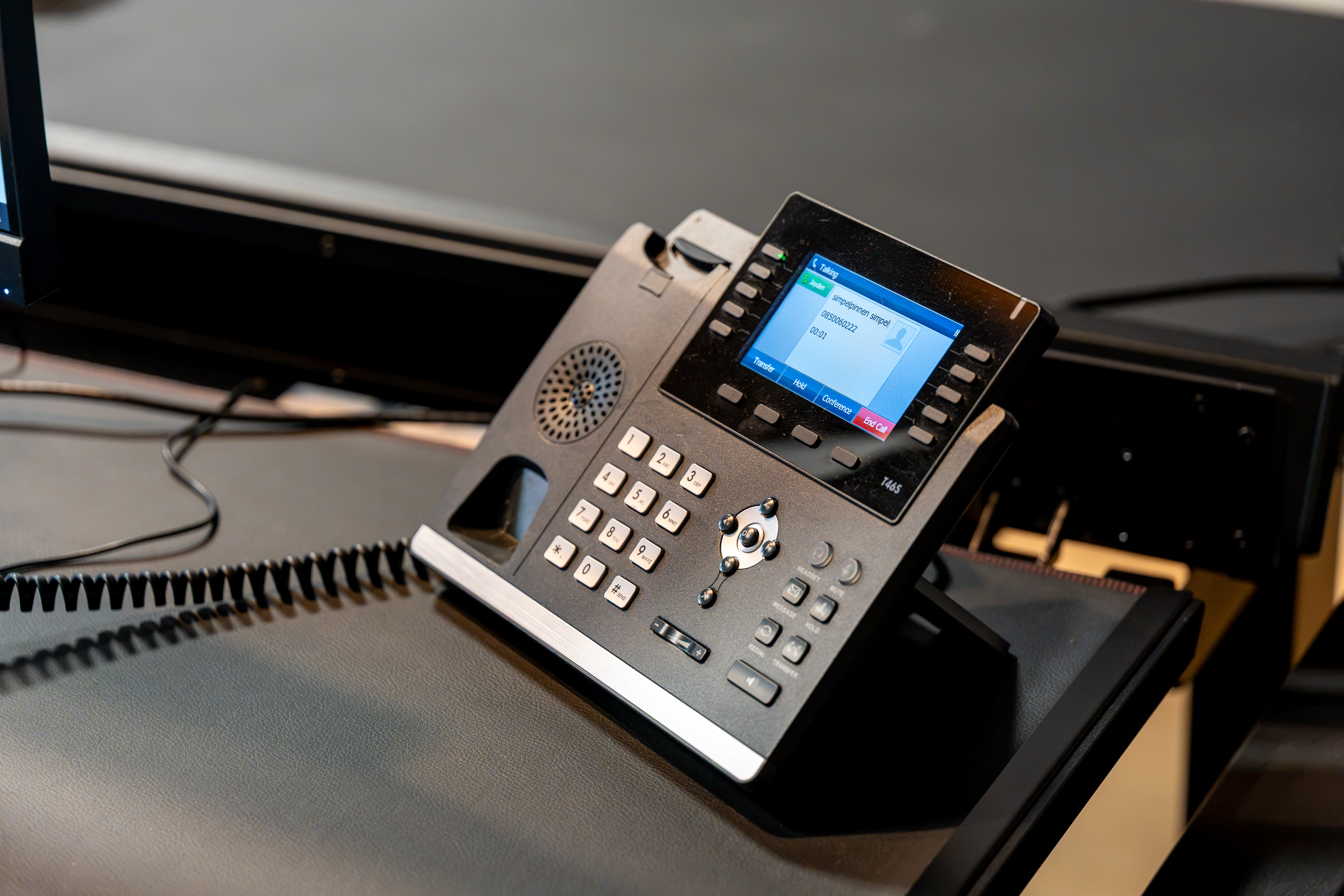 VoIP desk phone on a reception desk