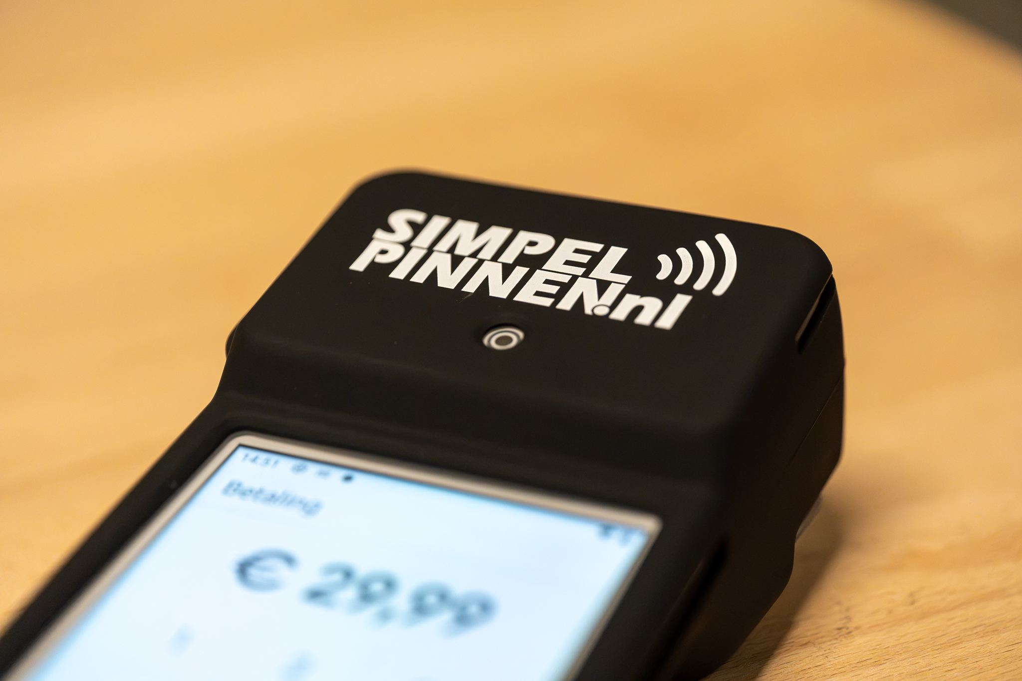 Portable card terminal showing a payment amount on screen