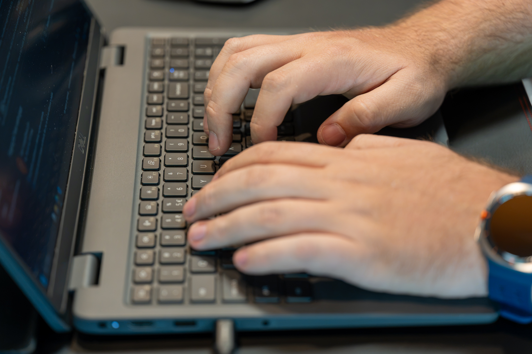 Employee typing on a laptop in a managed workplace